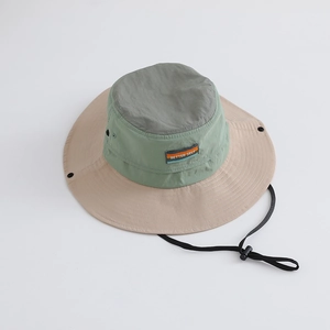 Detail of color-block sun hat featuring Better Self patch and adjustable windproof rope