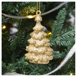 Close-up of golden glitter Christmas tree ornament hanging on a pine branch