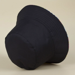 Double-sided reversible bucket hat with black exterior and colorful fruit print lining