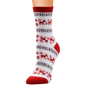 Close-up of white knitted Christmas socks with red reindeer and snowflake patterns