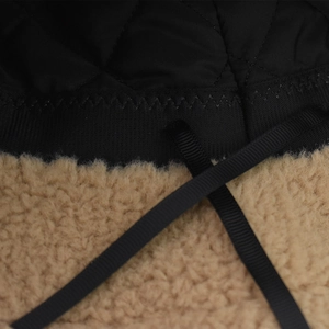 Macro view of plush teddy fleece texture and quilted lining detail of the bear bucket hat