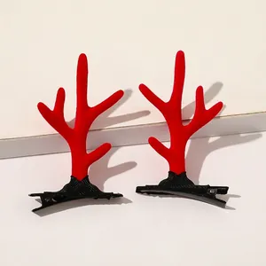 Close-up of festive red plush reindeer antler hair clips with anti-slip metal duckbill base