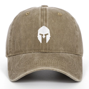 Close-up of Spartan helmet white embroidery on washed khaki cotton baseball cap