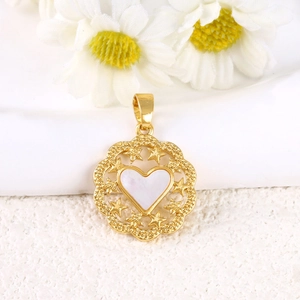 Detailed macro view of a gold-plated shell heart pendant with intricate star cutouts