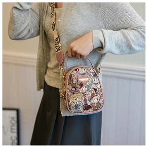 Detail of floral teddy bear crossbody bag with pink handle and branded wide strap