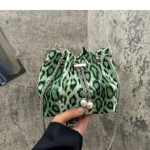 Green and black leopard print crossbody bucket bag with silver chain and pearl details