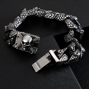 Detail of dark metal Cuban chain with skull and crossbones clasp in gothic style