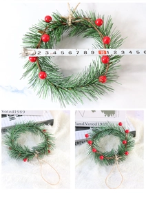 Detail shot of Christmas wreath with red berries and pine needles showing size measurement