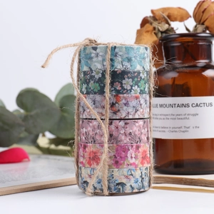 Close-up of 6-roll floral washi tape set tied with hemp rope for DIY scrapbooking