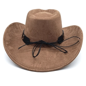 Detail of brown faux suede cowboy hat showing the woven black band and metal eyelet