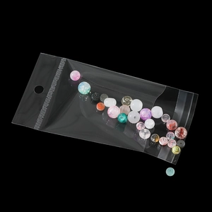 Macro detail of mixed color DIY jewelry beads in a clear self-sealing plastic bag
