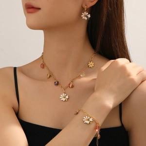 Gold bee and daisy jewelry set including necklace, bracelet and earrings on a model
