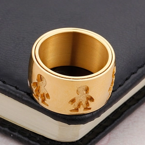 Golden double-layer stainless steel ring with cutout figures on black leather background