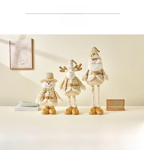 Detail of Christmas plush figurines with snowman, reindeer and Santa in gold knit fabric