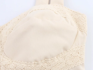 Detailed close-up of beige camisole featuring delicate lace trim and cotton linen texture