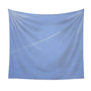 Detail of light blue tapestry featuring white vapor trail and woven fabric texture