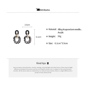 Detail view of acrylic oval earrings with zebra pattern, size 6.1cm by 3.5cm and 16g weight