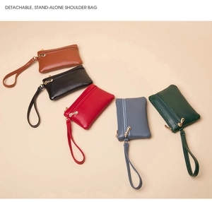 Detail of mini leather wallets with double zippers and wrist straps in five colors