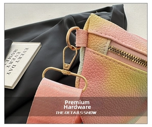 Detail of gradient pebble leather bag with gold hardware and pink fabric strap