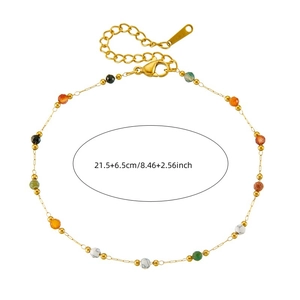 Golden stainless steel anklet with colorful beads and lobster clasp on white background