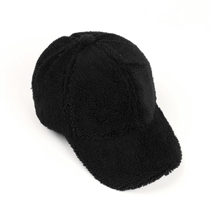 Macro detail of black teddy fleece baseball cap showing thick plush texture and stitching