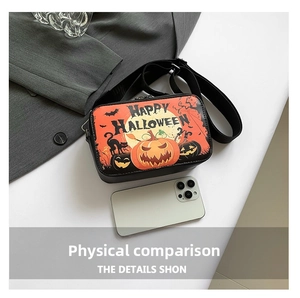 Detail view of Halloween crossbody bag with pumpkin print and phone for size comparison