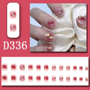 Red-pink gradient press-on nails set with sparkling rhinestones and crystal accents