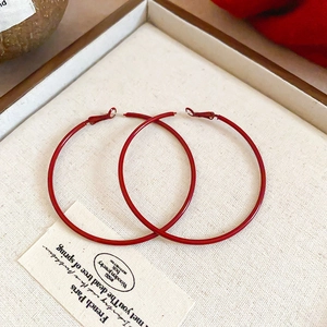 Detail view of retro red enamel square hoop earrings in a wooden jewelry gift box