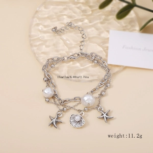 Detail view of silver layered bracelet with starfish charms and dimensions 17cm plus 7cm