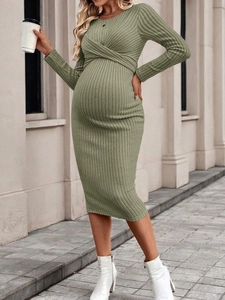 Green long-sleeve knit maternity dress featuring a twist detail and ribbed texture