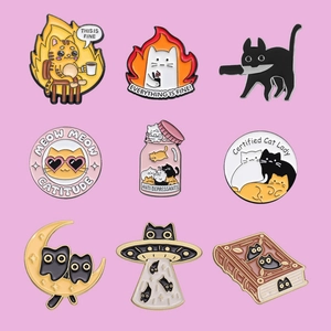 Set of 9 cute enamel cat pins with meme designs on a pink background for apparel
