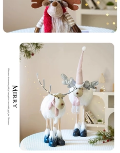 Detailed view of plush Christmas reindeer dolls with soft scarves and holiday decorations