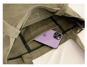 Internal view of army green canvas tote bag featuring a black zippered inner pocket