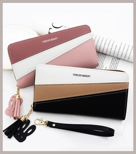 Detailed view of long patchwork zip wallets featuring rabbit charms and wristlet straps