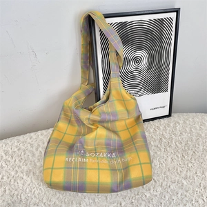 Detailed view of large capacity yellow and purple plaid canvas tote bag with embroidery