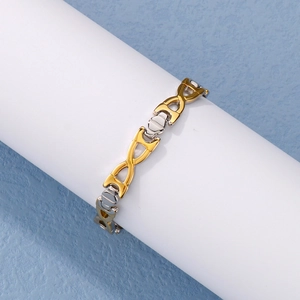 Macro shot of two-tone gold and silver X-link titanium steel bracelet on a display stand