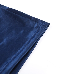 Detail view of smooth dark blue satin fabric with professional double-stitched hem finish