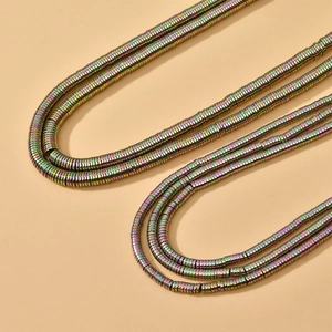 Close-up of colorful multi-layer hematite stone necklaces with metallic disc beads