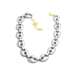 Detail view of matte silver coffee bean chain necklace with golden lobster clasp and adjuster