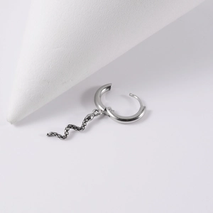 Detailed close-up of a silver stainless steel hoop earring with a textured snake pendant