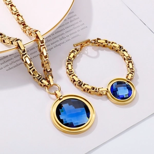 Detail of golden Byzantine chain jewelry set with round blue gemstones and T-bar toggle clasp