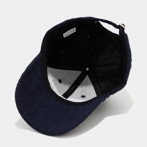 Inside view of navy corduroy baseball cap with white mesh lining and adjustable strap