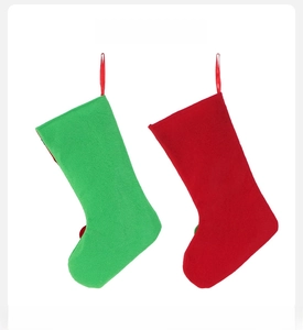 Back view of red and green felt Christmas stockings showing plain minimalist design