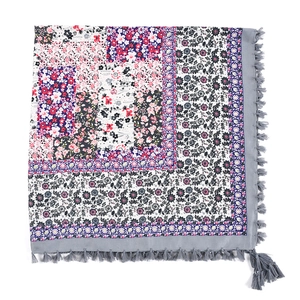 Detailed view of bohemian square scarf with ethnic floral patterns and gray fringe trim