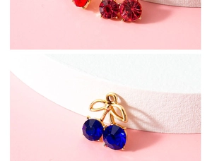 Macro shot of gold alloy cherry pendants with red and blue crystals for DIY jewelry