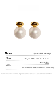 Detail view showing elegant white pearl earrings with gold bean accent and silver needles