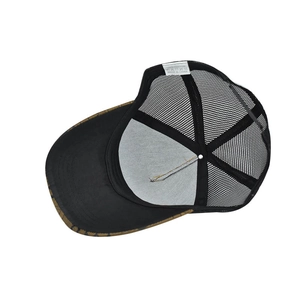 Detail view of the houndstooth baseball cap's breathable mesh and 100% cotton label