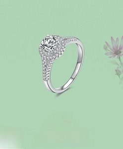 Close-up of S925 sterling silver ring with round halo diamond setting and pavé band