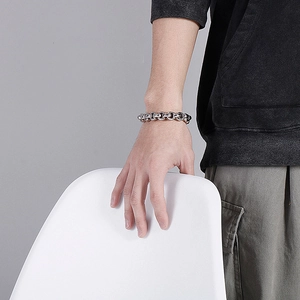 Men's silver thick chain bracelet in D-link industrial style worn by a model