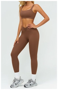 Detail of high-waisted yoga leggings with V-shaped waistband and matte brown fabric
